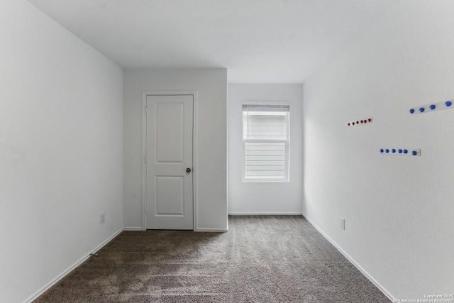 unfurnished bedroom with baseboards and carpet flooring