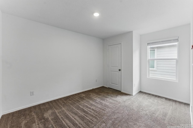 carpeted empty room with recessed lighting and baseboards