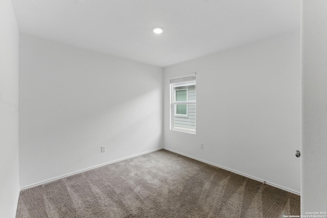 empty room with baseboards and carpet floors