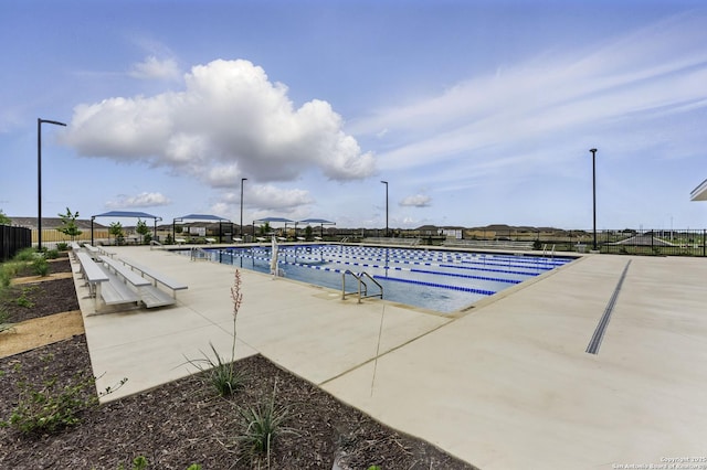 pool with fence and a patio area