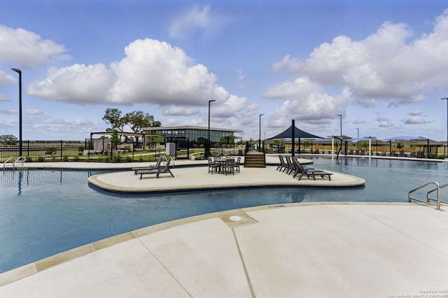pool with fence and a patio