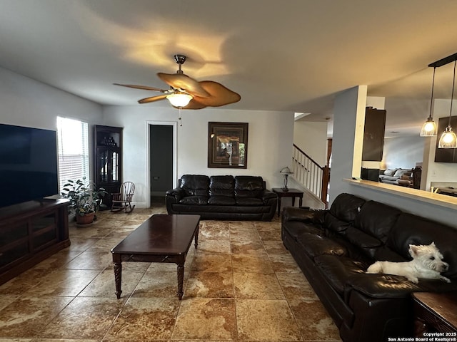 9528 Braun, San Antonio, TX 78254 - living area with stairs, a ceiling fan, and stone finish floor