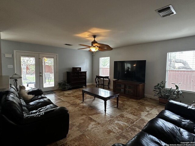 9528 Braun, San Antonio, TX 78254 - living area featuring stone finish floor, visible vents, french doors, and a ceiling fan
