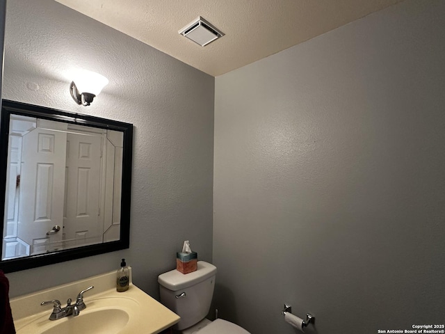 9528 Braun, San Antonio, TX 78254 - half bath featuring toilet, visible vents, and vanity