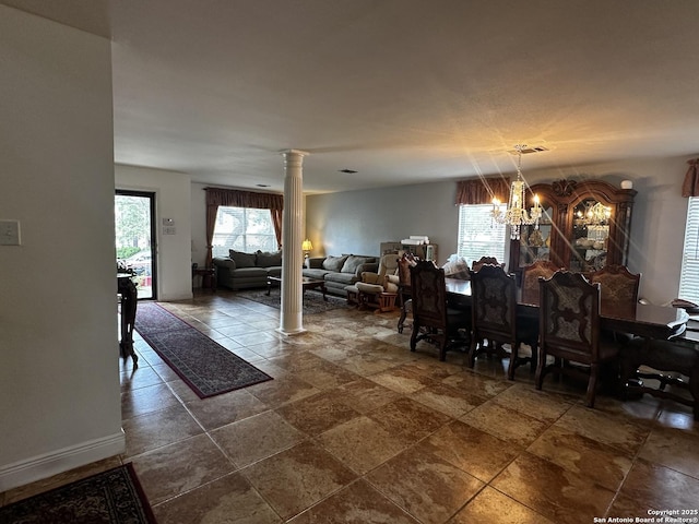 9528 Braun, San Antonio, TX 78254 - dining area featuring stone tile floors, ornate columns, visible vents, and a notable chandelier