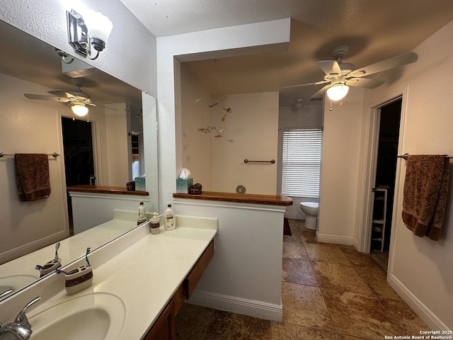 9528 Braun, San Antonio, TX 78254 - full bathroom featuring toilet, a ceiling fan, vanity, and baseboards