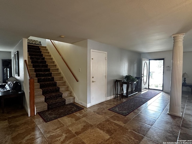9528 Braun, San Antonio, TX 78254 - foyer with decorative columns, stone tile flooring, baseboards, and stairs