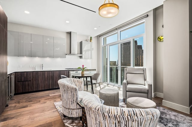dining space featuring wood finished floors, recessed lighting, and baseboards