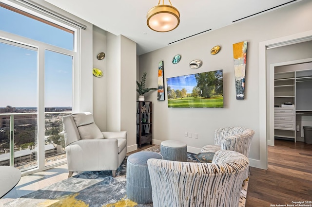 living area featuring baseboards and wood finished floors