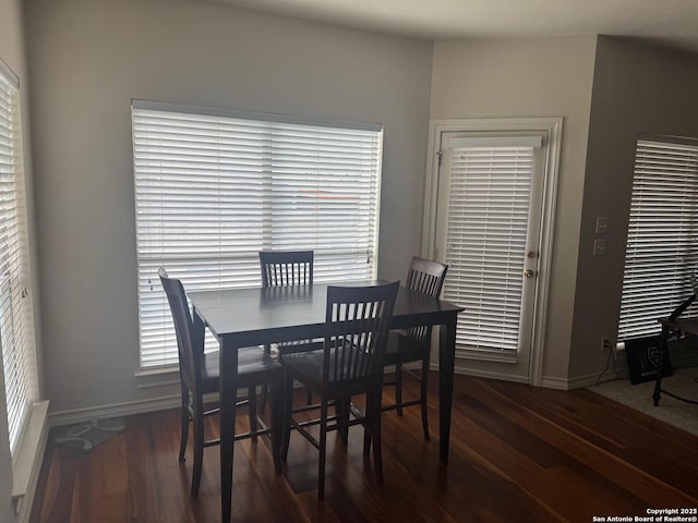 dining space with a healthy amount of sunlight, wood finished floors, and baseboards