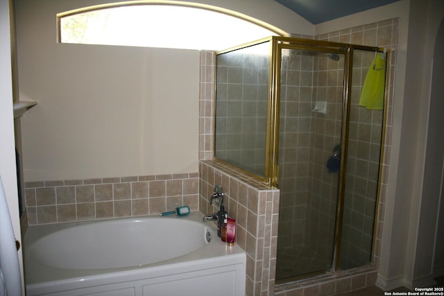bathroom featuring a garden tub and a stall shower