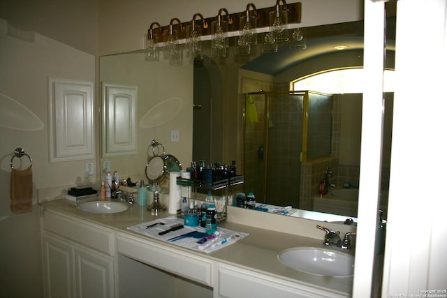 full bathroom with double vanity, a tub to relax in, a stall shower, and a sink