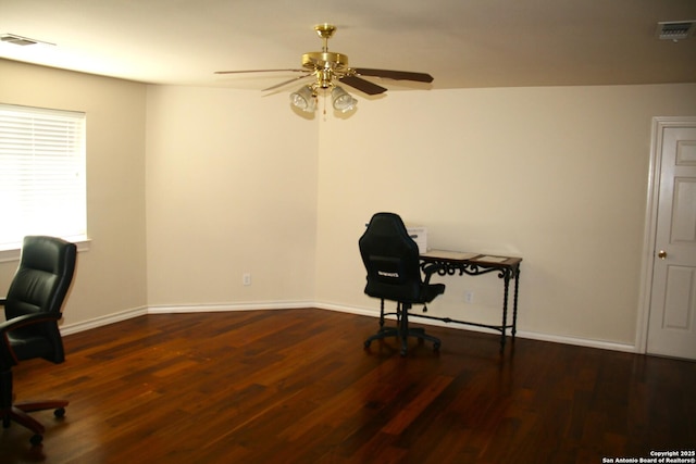 unfurnished office with a ceiling fan, visible vents, and wood finished floors