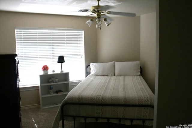 bedroom with a ceiling fan, baseboards, and carpet floors