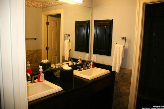 bathroom featuring double vanity and a sink