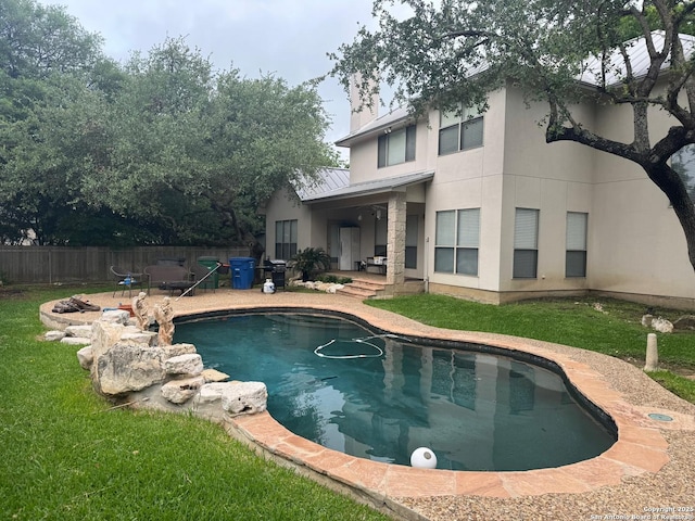 view of pool with fence, a lawn, a patio, and a fenced in pool