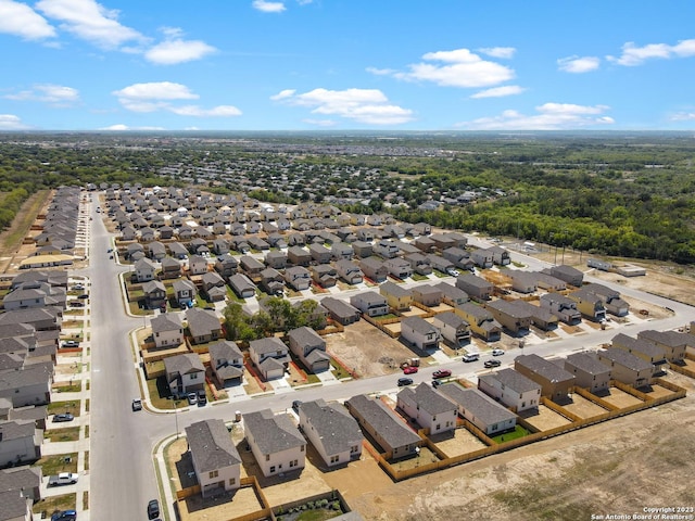 aerial view featuring a forest view and a residential view