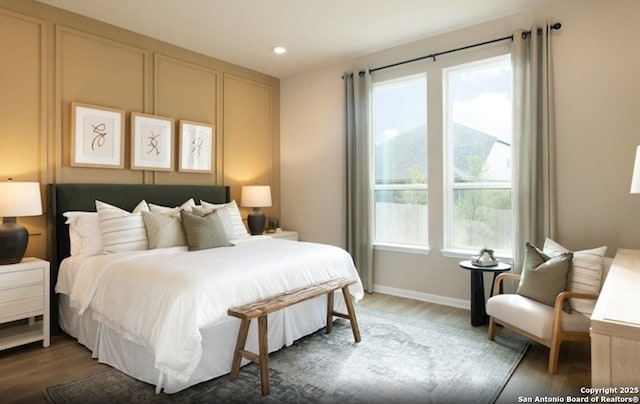 bedroom with wood finished floors, recessed lighting, and baseboards