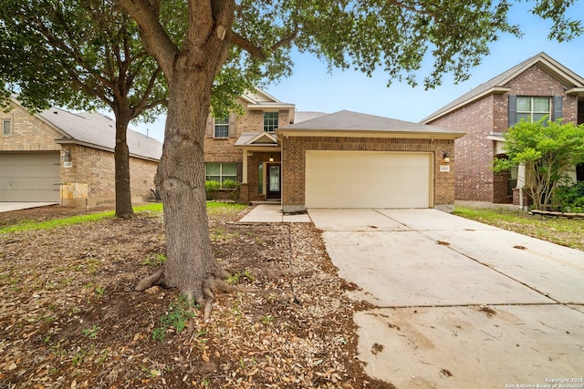 traditional-style house with a garage, brick siding, and driveway