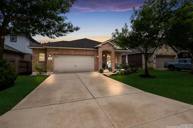 ranch-style house with brick siding, concrete driveway, an attached garage, and a lawn