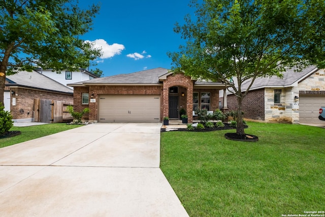 view of front of home featuring brick siding, fence, a front yard, concrete driveway, and an attached garage