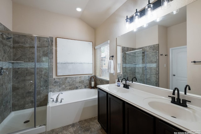 full bath featuring a sink, a shower stall, and lofted ceiling