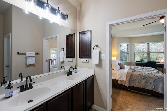 bathroom featuring a healthy amount of sunlight, ensuite bath, and a sink