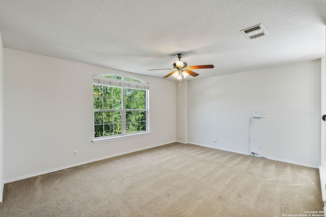 unfurnished room featuring visible vents, ceiling fan, carpet flooring, and baseboards