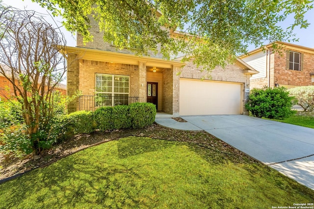 traditional-style house with a garage, brick siding, a front lawn, and driveway