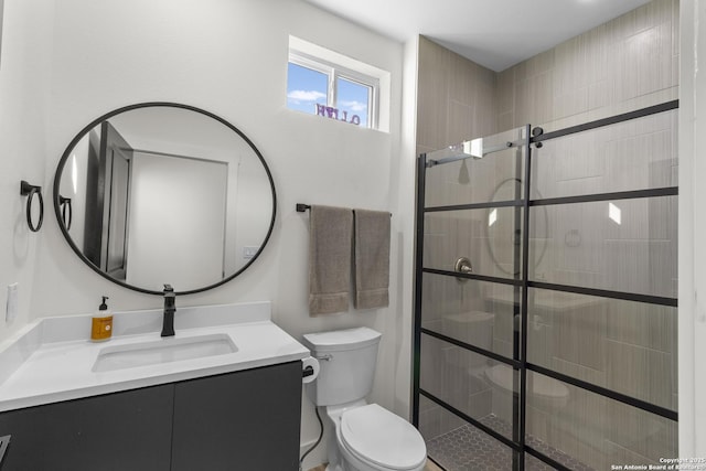 full bathroom with toilet, a tile shower, and vanity