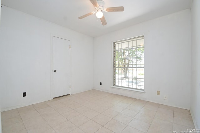 spare room featuring light tile patterned floors and ceiling fan