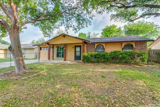 6835 Spring Hurst, San Antonio, TX 78249 - single story home with brick siding, fence, stucco siding, and a front yard
