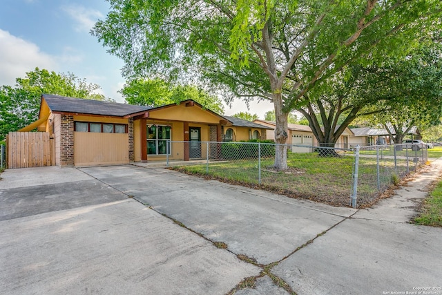 6835 Spring Hurst, San Antonio, TX 78249 - ranch-style house featuring brick siding, a fenced front yard, and driveway