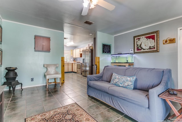 6835 Spring Hurst, San Antonio, TX 78249 - living area with ceiling fan, visible vents, baseboards, ornamental molding, and dark tile patterned floors