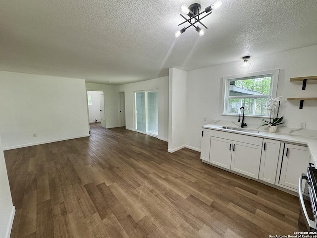629 Melrose, Seguin, TX 78155 - kitchen featuring a textured ceiling, a sink, wood finished floors, and open floor plan
