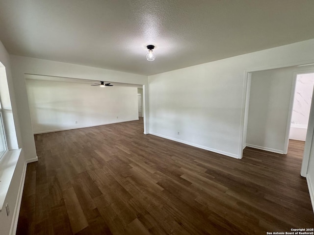 629 Melrose, Seguin, TX 78155 - empty room featuring baseboards, a ceiling fan, a textured ceiling, and dark wood-style flooring