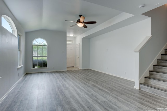 6015 Wexford Pl, San Antonio, TX 78240 - unfurnished living room featuring wood finished floors, stairs, ceiling fan, baseboards, and lofted ceiling