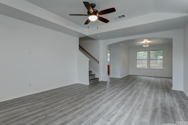 6015 Wexford Pl, San Antonio, TX 78240 - unfurnished living room featuring ceiling fan, stairs, visible vents, arched walkways, and wood finished floors