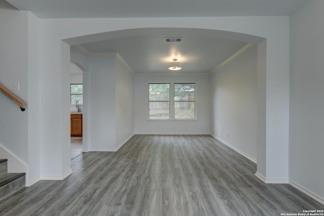 6015 Wexford Pl, San Antonio, TX 78240 - unfurnished dining area featuring arched walkways, a wealth of natural light, and wood finished floors
