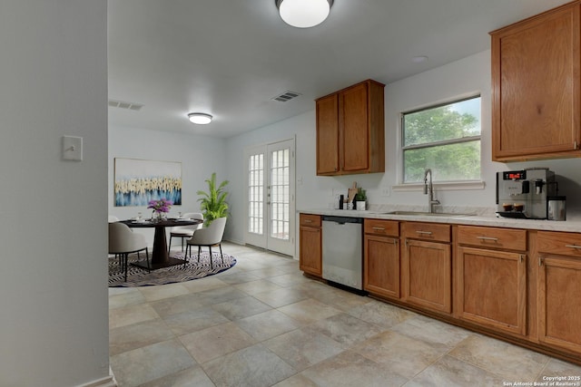 6015 Wexford Pl, San Antonio, TX 78240 - kitchen featuring visible vents, stainless steel dishwasher, brown cabinetry, and a sink
