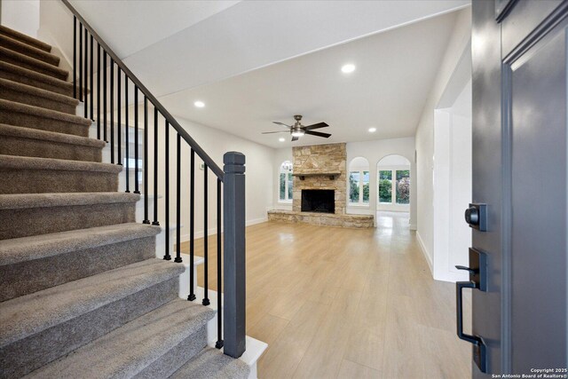 interior space with stairway, ceiling fan, baseboards, and light wood-style floors
