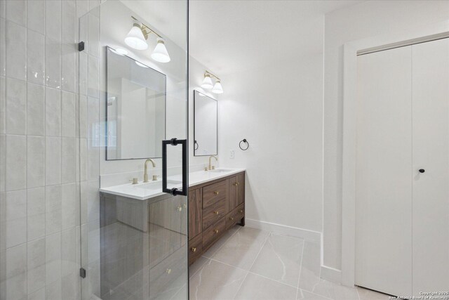 full bath with a shower stall, a sink, double vanity, baseboards, and tile patterned flooring