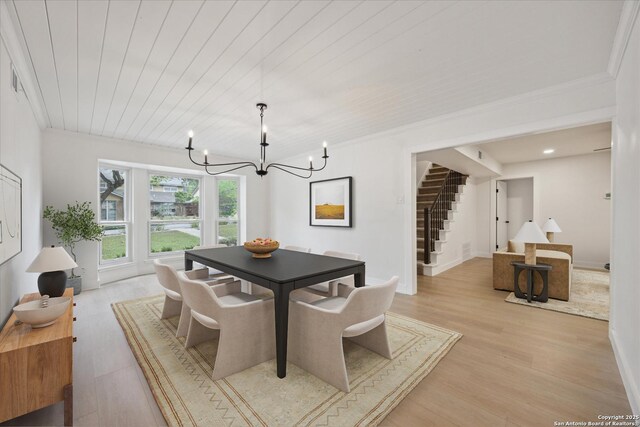 dining space with wooden ceiling, an inviting chandelier, stairs, light wood finished floors, and baseboards