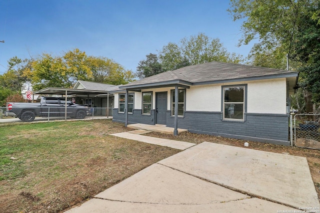 ranch-style home with fence, a carport, and a front yard