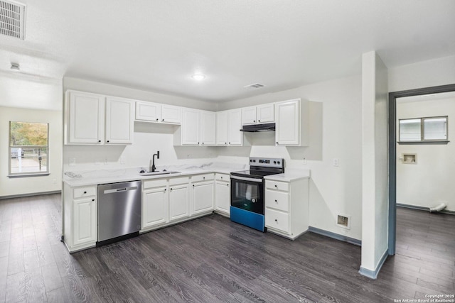 kitchen featuring dark wood-type flooring, visible vents, stainless steel appliances, and a sink