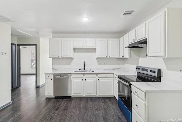 kitchen featuring dark wood-style floors, a sink, under cabinet range hood, white cabinets, and appliances with stainless steel finishes