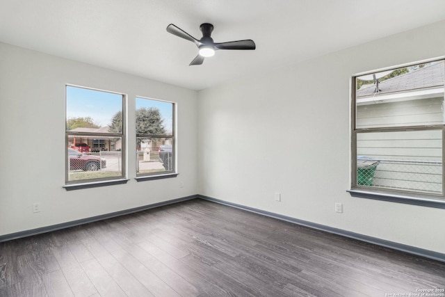spare room with ceiling fan, baseboards, wood finished floors, and a healthy amount of sunlight