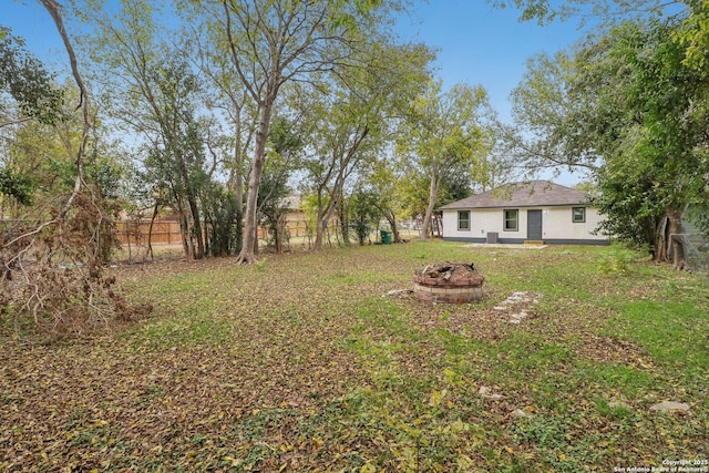 view of yard with an outdoor fire pit and a fenced backyard