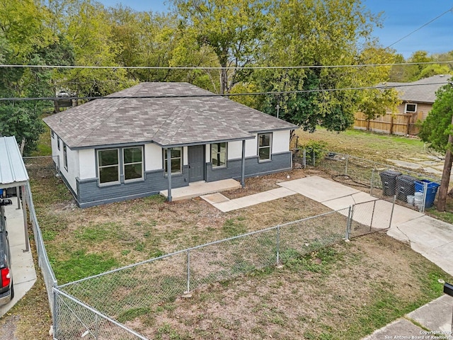 view of front of house with fence private yard, covered porch, and roof with shingles