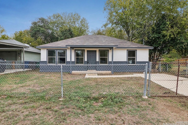 view of front of house featuring a front yard, a shingled roof, and fence private yard